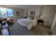 Neutral bedroom featuring plush carpet, modern lamps, accent furniture, and a comfortable, well-lit space at 12506 E Cornell Ave # 201, Aurora, CO 80014