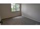 An empty bedroom with a window and neutral walls and carpet at 12506 E Cornell Ave # 201, Aurora, CO 80014