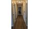 Hallway with wood-look floors leading to bedrooms and closets at 12506 E Cornell Ave # 201, Aurora, CO 80014