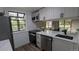 Bright kitchen featuring white cabinets, quartz countertops, and stainless steel appliances at 12506 E Cornell Ave # 201, Aurora, CO 80014