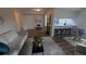 Open floor plan featuring a living room connected to a modern kitchen with a breakfast bar at 12506 E Cornell Ave # 201, Aurora, CO 80014