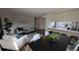 Open concept living area with dining room and kitchen featuring stylish furniture and decor at 12506 E Cornell Ave # 201, Aurora, CO 80014