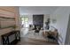 Open living room with fireplace, neutral furniture, and a sliding glass door to let in lots of light at 12506 E Cornell Ave # 201, Aurora, CO 80014