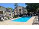 Community pool with lounge chairs surrounded by manicured landscaping and building at 12506 E Cornell Ave # 201, Aurora, CO 80014