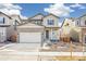 Exterior view of a new two story home with a large driveway and neutral siding at 13432 E 110Th Way, Commerce City, CO 80022