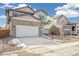 New home with neutral siding, stone accents, well-manicured yard, and large driveway at 13432 E 110Th Way, Commerce City, CO 80022