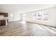 Expansive living room with hardwood floors, bright white walls, and an abundance of natural light at 13432 E 110Th Way, Commerce City, CO 80022