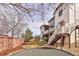 Spacious backyard featuring a lawn, brick wall and mature trees at 9591 Sunset Hill Dr, Lone Tree, CO 80124