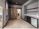 Basement bar area featuring beverage refrigerators, open shelves and a rustic barn door at 9591 Sunset Hill Dr, Lone Tree, CO 80124