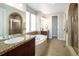 Bathroom featuring dual sinks, a soaking tub, a separate shower, and elegant tile work at 9591 Sunset Hill Dr, Lone Tree, CO 80124