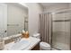 Well-lit bathroom with a shower, modern vanity, large mirror, and neutral color scheme at 9591 Sunset Hill Dr, Lone Tree, CO 80124