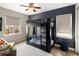 Stylish bedroom with a black bunk bed, blue accent wall, and natural light at 9591 Sunset Hill Dr, Lone Tree, CO 80124