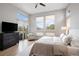 Bright primary bedroom with big windows, hardwood floors, and a sliding door to a balcony at 9591 Sunset Hill Dr, Lone Tree, CO 80124
