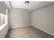 Cozy bedroom with carpet flooring, neutral paint and a large window at 9591 Sunset Hill Dr, Lone Tree, CO 80124