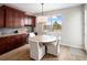 Cozy eating area showcases dark wood cabinets, light countertops and a beautiful window view at 9591 Sunset Hill Dr, Lone Tree, CO 80124