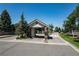 Community entrance featuring brick pillars and manicured landscaping at 9591 Sunset Hill Dr, Lone Tree, CO 80124