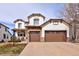 Stunning two-story stucco home with a three-car garage, stone accents, and well-manicured landscaping at 9591 Sunset Hill Dr, Lone Tree, CO 80124