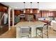 Gourmet kitchen features stainless steel appliances, granite countertops, a large island, and stylish pendant lighting at 9591 Sunset Hill Dr, Lone Tree, CO 80124