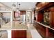Well-equipped kitchen featuring a center island with seating, stainless appliances, and custom wood cabinets at 9591 Sunset Hill Dr, Lone Tree, CO 80124