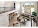 Open concept floor plan featuring a living room, dining area, and kitchen with large windows at 9591 Sunset Hill Dr, Lone Tree, CO 80124