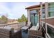 Relaxing outdoor patio with comfortable wicker furniture and picturesque views of the surroundings at 9591 Sunset Hill Dr, Lone Tree, CO 80124
