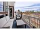 Comfortable outdoor patio featuring a wicker sofa, chair, and a scenic view at 9591 Sunset Hill Dr, Lone Tree, CO 80124