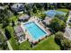 Aerial view of a community pool, tennis courts, and surrounding greenery at 9591 Sunset Hill Dr, Lone Tree, CO 80124