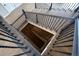 View of an interior staircase with stained wood treads and decorative wrought iron spindles at 9591 Sunset Hill Dr, Lone Tree, CO 80124