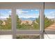 Panoramic view of the mountains and rooftops from the window of the home at 9591 Sunset Hill Dr, Lone Tree, CO 80124