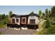 Modern townhouse exterior with wood and stone accents, two levels, balconies, and garage spaces, with lush landscaping at 526 N Fuller Placer Rd, Breckenridge, CO 80424