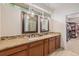 Stylish bathroom with double vanities, granite countertops, and a view into the walk-in closet at 7777 Newman St, Arvada, CO 80005
