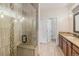 Modern bathroom with tiled walk-in shower, granite countertops, and tiled floors for a luxurious feel at 7777 Newman St, Arvada, CO 80005