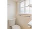 Bright half bathroom features modern toilet and fixtures, and a window at 7777 Newman St, Arvada, CO 80005