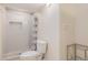 Bright bathroom featuring a shower with decorative tile, a toilet, and neutral walls, creating a clean and modern space at 7777 Newman St, Arvada, CO 80005