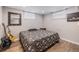 This stylish bedroom has a statement mirror, guitar and wood-look flooring, offering a cozy retreat at 7777 Newman St, Arvada, CO 80005