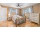 Cozy bedroom features natural light from two windows, hardwood floors and furniture at 7777 Newman St, Arvada, CO 80005