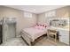 Cozy bedroom featuring wood floors, two windows, and a vanity area, perfect for relaxation at 7777 Newman St, Arvada, CO 80005