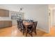 Bright dining area with hardwood floors, a large window, and a spacious dining table with seating for eight at 7777 Newman St, Arvada, CO 80005
