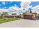 Expansive driveway and charming exterior of this well-maintained home, complete with an American flag at 7777 Newman St, Arvada, CO 80005