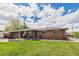 Inviting brick home with a well-kept lawn and charming front porch, perfect for enjoying the outdoors at 7777 Newman St, Arvada, CO 80005
