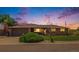 Charming brick home featuring a manicured lawn, mature landscaping, and attached garage, creating a welcoming curb appeal at 7777 Newman St, Arvada, CO 80005