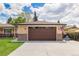 Detached garage featuring a large door and classic design, complemented by a lush green lawn and American flag at 7777 Newman St, Arvada, CO 80005