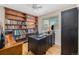 Functional home office featuring built-in bookshelf, a computer desk, and natural light at 7777 Newman St, Arvada, CO 80005