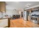 Open concept kitchen with stainless steel appliances adjacent to a dining area, creating flow and functionality at 7777 Newman St, Arvada, CO 80005