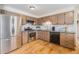 Traditional kitchen featuring stainless steel appliances and wooden cabinets with tile backsplash, provides functionality at 7777 Newman St, Arvada, CO 80005