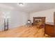 Traditional living room featuring a brick fireplace, hardwood floors, and neutral decor at 7777 Newman St, Arvada, CO 80005
