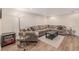 Living room features a large sectional sofa, hardwood floors, and neutral paint at 7777 Newman St, Arvada, CO 80005