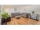 Comfortable living room featuring plush sofas, hardwood floors, and a modern glass coffee table, perfect for relaxation at 7777 Newman St, Arvada, CO 80005