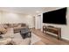 Cozy living room with comfortable seating, recessed lighting, and a mounted television at 7777 Newman St, Arvada, CO 80005