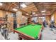 Spacious storage area featuring a pool table and ample storage boxes, perfect for organization and recreation at 7777 Newman St, Arvada, CO 80005